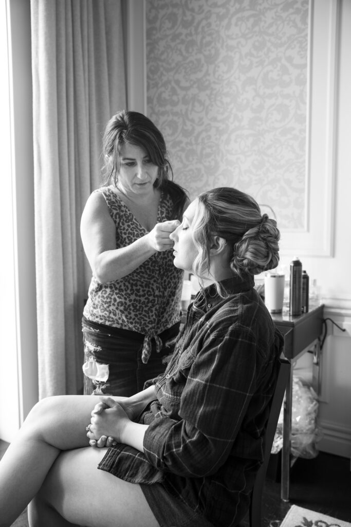 Bride getting ready at a wedding at the Adelphi Hotel by Saratoga wedding photographer Caitlin Miller