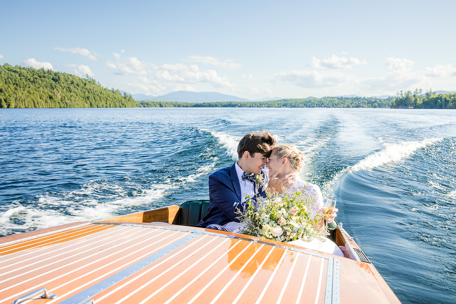 Newlyweds on a boat ride on Lake Placid, form a wedding at the Whiteface Golf Club Lake Placid