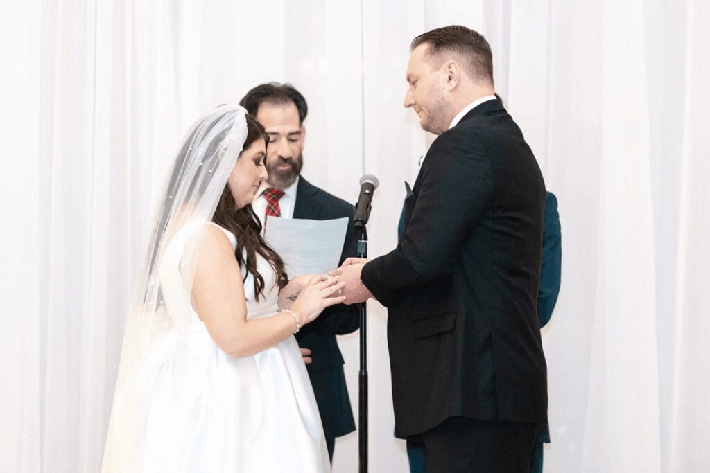 Bride and groom at the ceremony saying their vows at hall of springs saratoga ny.
