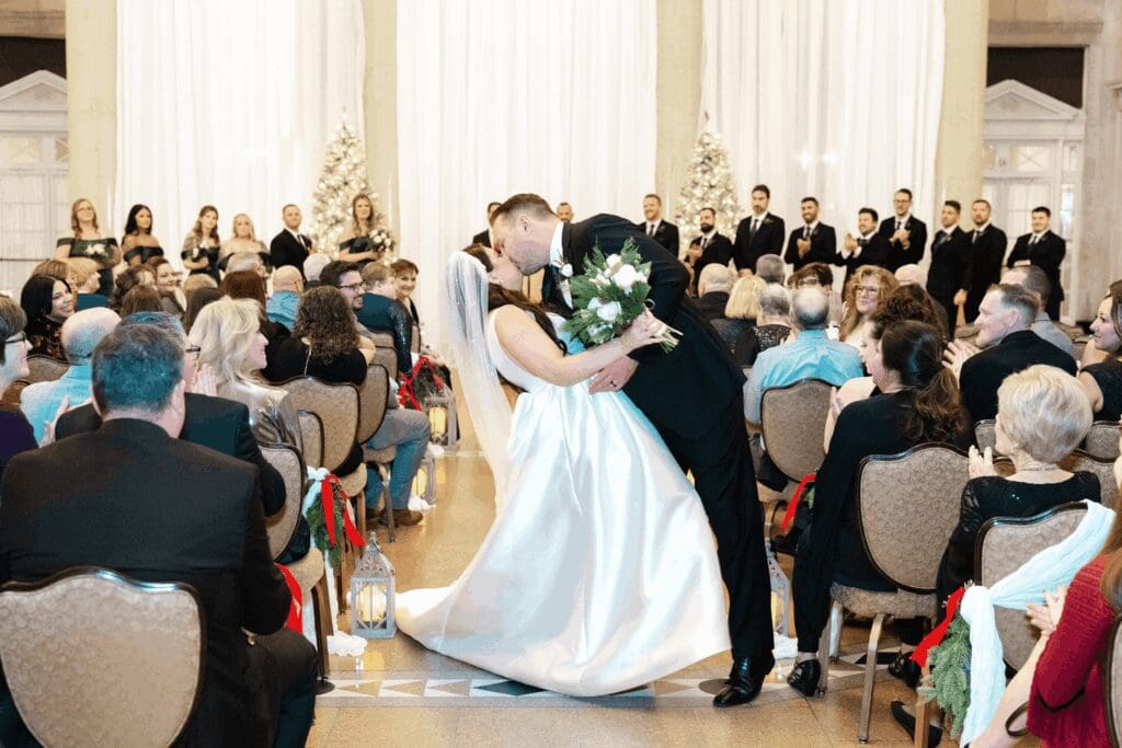 Bride and groom celebrating their vows in a dipping style kiss at hall of springs saratoga ny.