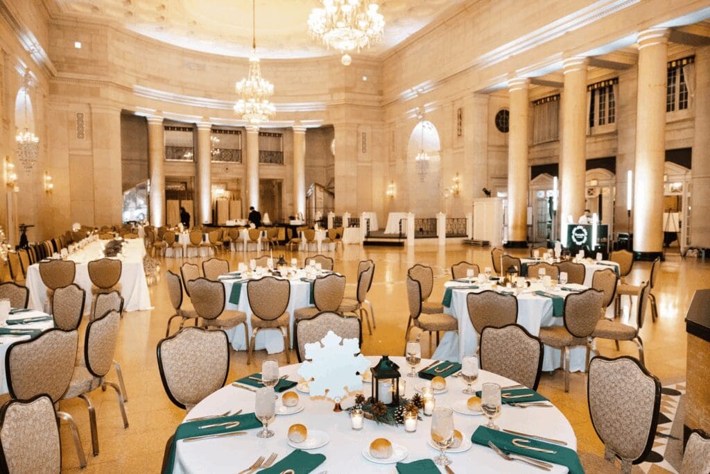 Photo by Caitlin Miller of the reception at The Hall of Springs Saratoga NY. Tables are adorned with linens, glass stemware and decor.