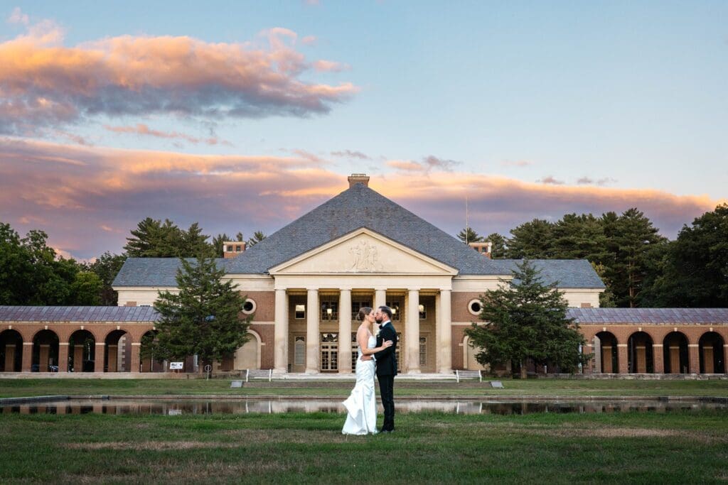 Newlyweds kissing during sunset at Saratoga Spa State Park after their ceremony