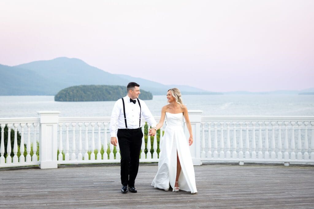 Bride and groom at The Sagamore Resort sunset with Adirondack Mountains behind them